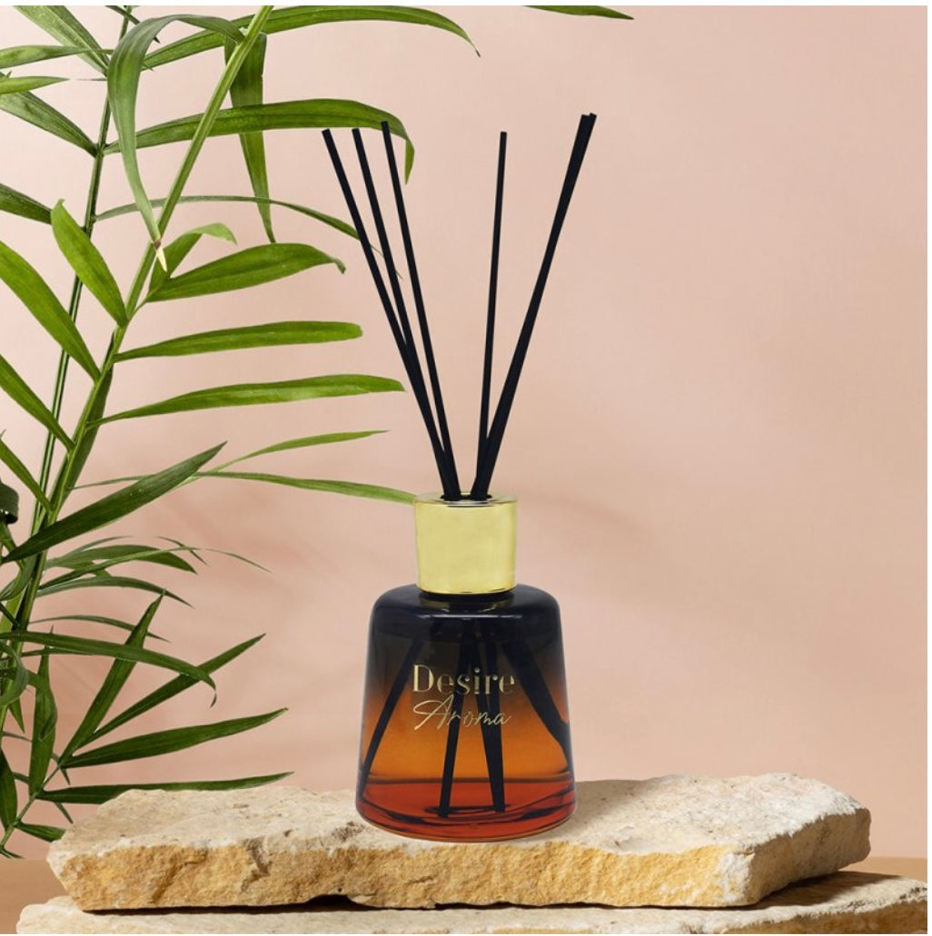 Amber and Sandalwood reed diffuser on a sandstone slab